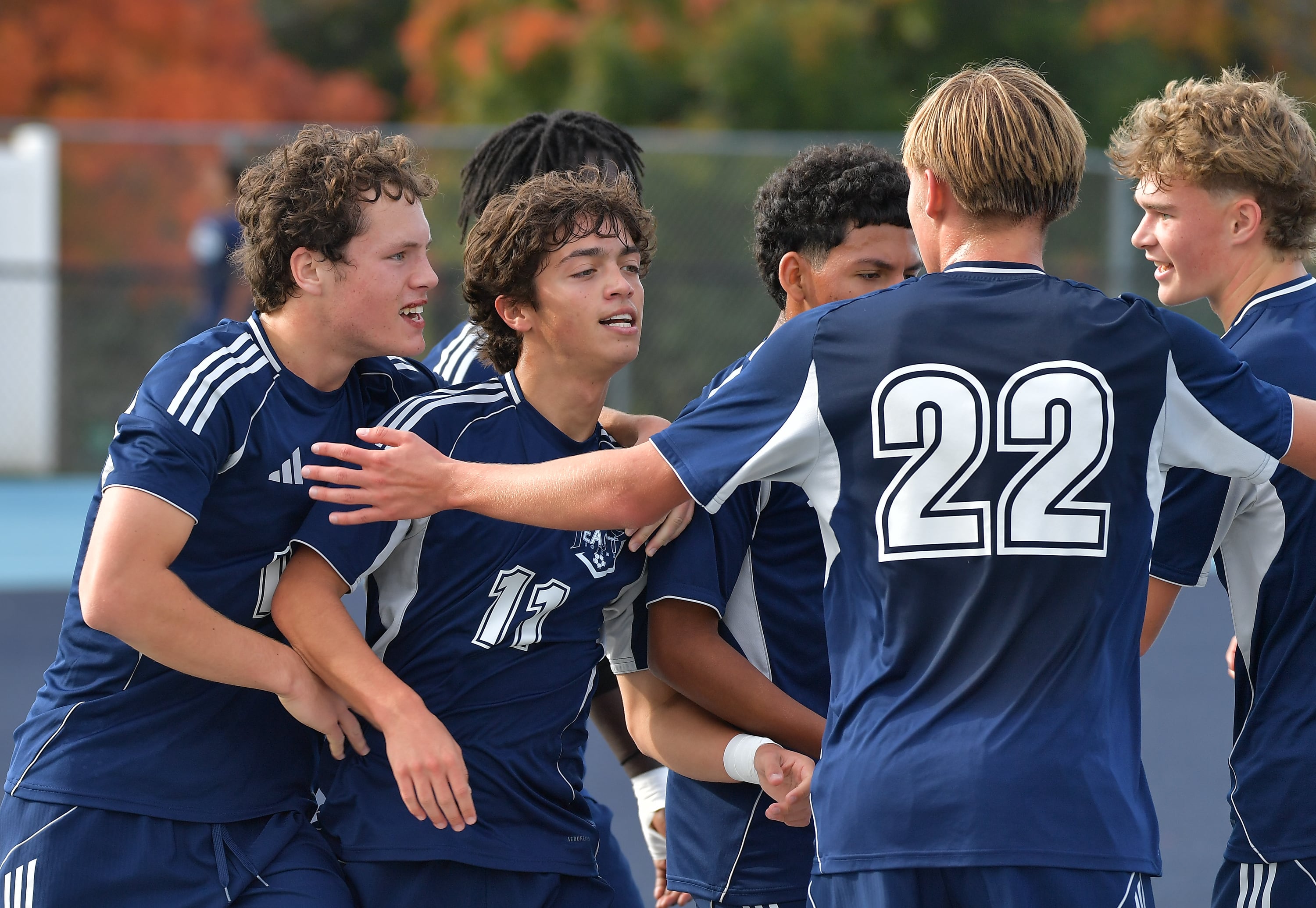 Oswego East Wolves soccer team celebrates a hard-fought victory on the field, capturing the essence of their historic season.